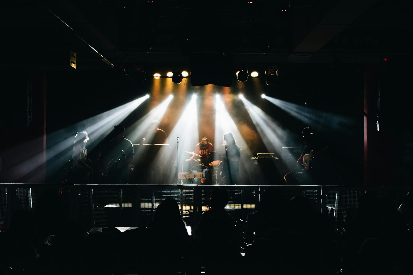 Live music concert with musicians on stage under dramatic lighting