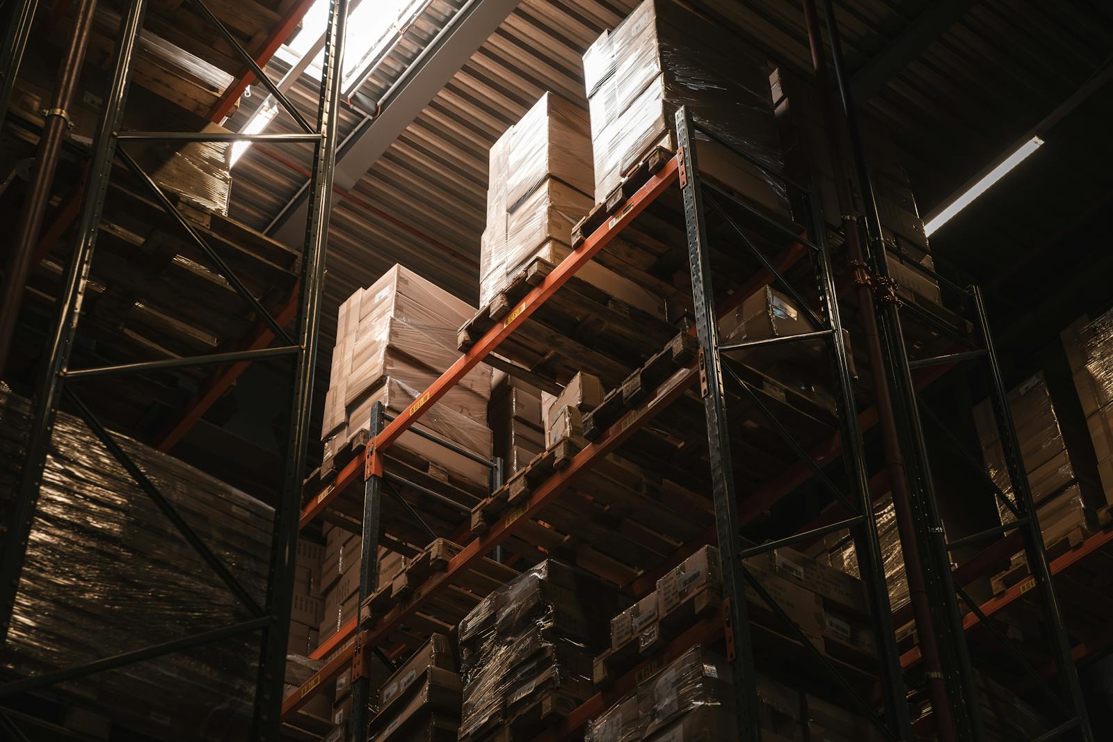 Warehouse interior with stacked boxes on high shelves for logistics and storage
